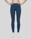 Model wearing TrackLine Sculpt Leggings in blue and white front view