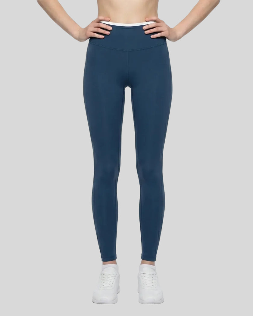 Model wearing TrackLine Sculpt Leggings in blue and white front view