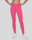 Angled front view of model wearing TrackLine Sculpt Leggings in pink and white