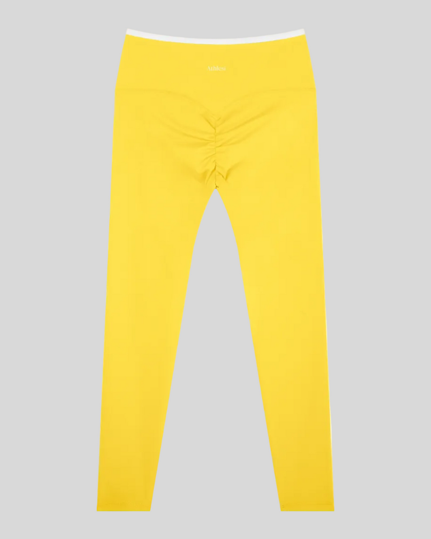 Back view of TrackLine Sculpt Leggings in yellow and white with contour shaping and ruched detail