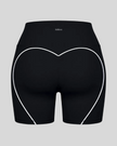 Back view of black TrackLine Sculpt Shorts featuring distinctive curved white contrast piping