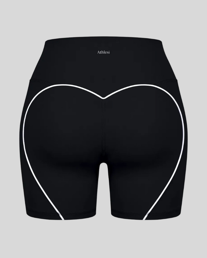 Back view of black TrackLine Sculpt Shorts featuring distinctive curved white contrast piping
