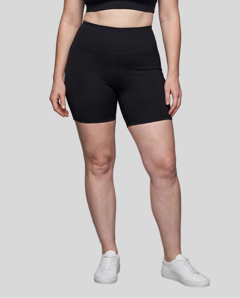 Lower body front view of woman wearing black TrackLine Sculpt Shorts with high-rise waistband