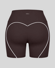 Back view of brown TrackLine Sculpt Shorts featuring distinctive curved white contrast piping