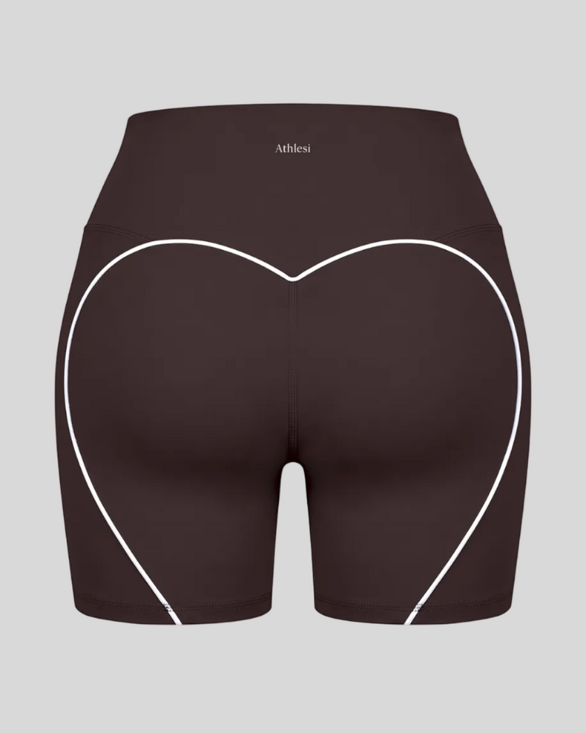 Back view of brown TrackLine Sculpt Shorts featuring distinctive curved white contrast piping