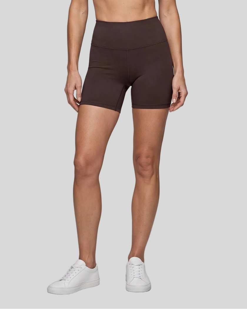 Lower body front view of woman wearing brown TrackLine Sculpt Shorts with high-rise waistband