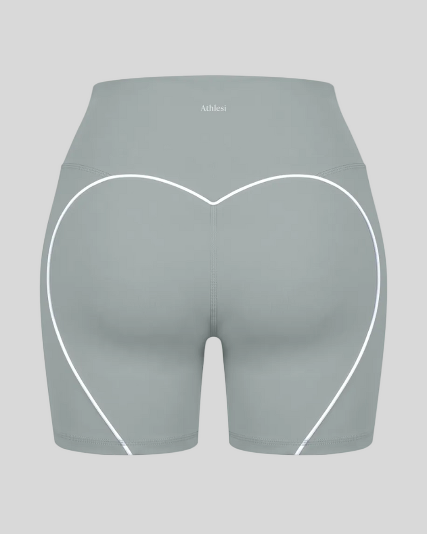 Back view of haze blue TrackLine Sculpt Shorts featuring distinctive curved white contrast piping