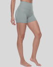 Angled front view of woman wearing fitted haze blue TrackLine Sculpt Shorts