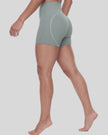 Lower body side angle view of woman wearing haze blue TrackLine Sculpt Shorts showing streamlined fit