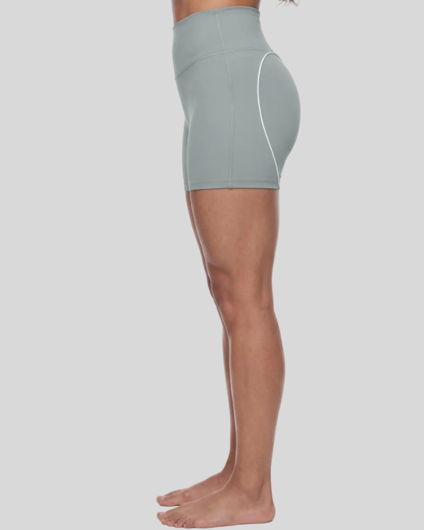 Lower body side view of woman wearing haze blue TrackLine Sculpt Shorts showing streamlined fit