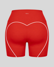 Back view of red TrackLine Sculpt Shorts featuring distinctive curved white contrast piping