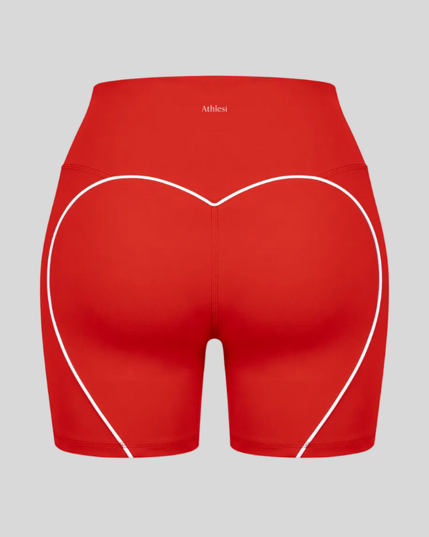 Back view of red TrackLine Sculpt Shorts featuring distinctive curved white contrast piping