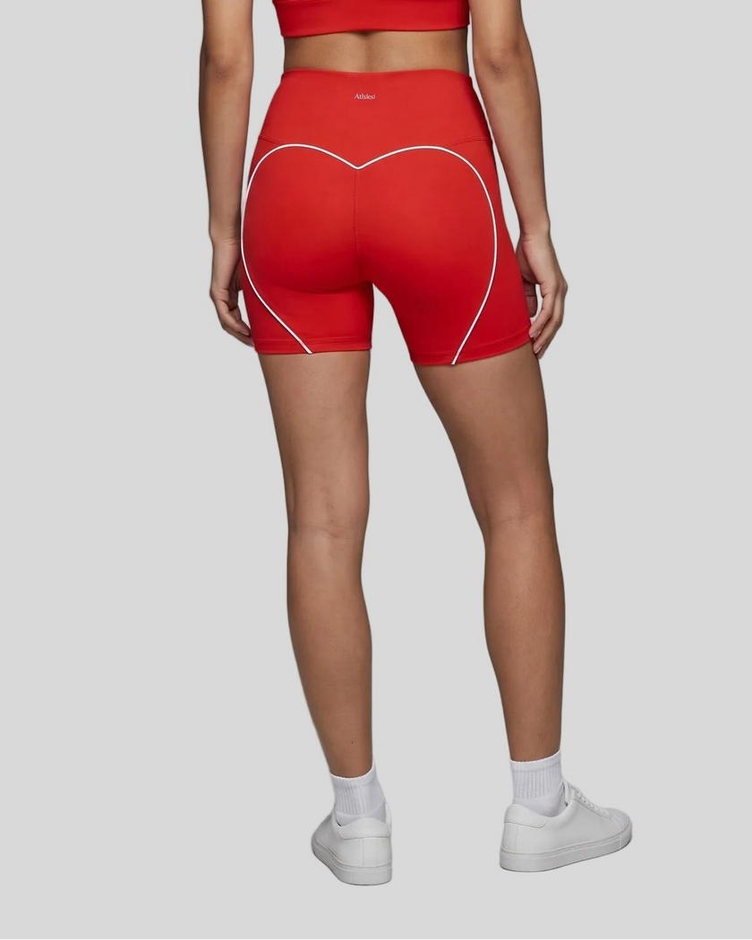 Lower body back view of woman wearing red TrackLine Sculpt Shorts with curved contrast piping
