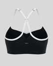Back view of black TrackLine Sculpt Sports Bra featuring white crossover straps and open-back design
