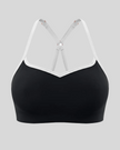 Front view of TrackLine Sculpt Sports Bra in black with white contrast trim and V-neckline