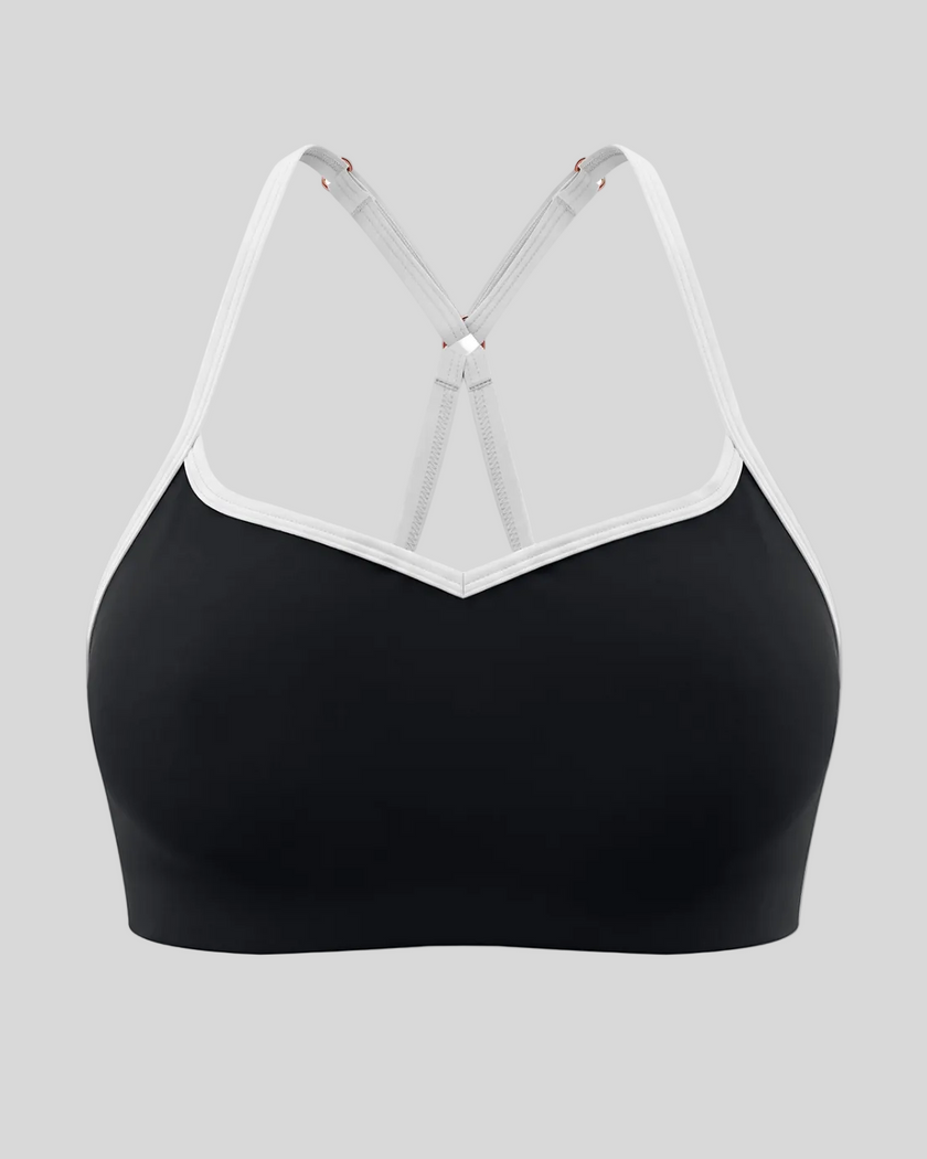 Front view of TrackLine Sculpt Sports Bra in black with white contrast trim and V-neckline