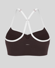 Back view of brown TrackLine Sculpt Sports Bra featuring white crossover straps and open-back design