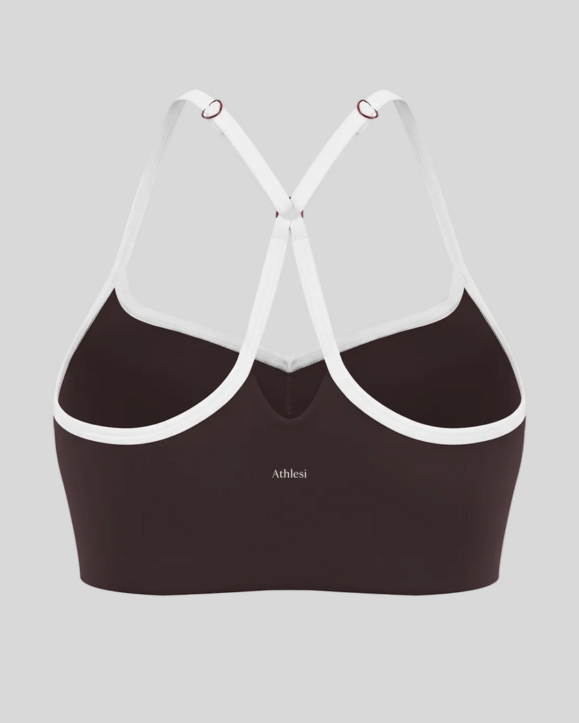 Back view of brown TrackLine Sculpt Sports Bra featuring white crossover straps and open-back design