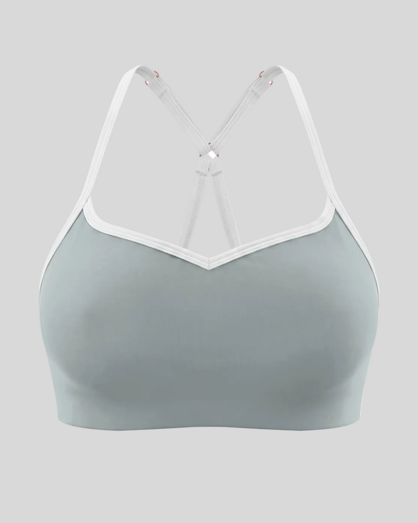 Front view of TrackLine Sculpt Sports Bra in haze blue with white contrast trim and V-neckline