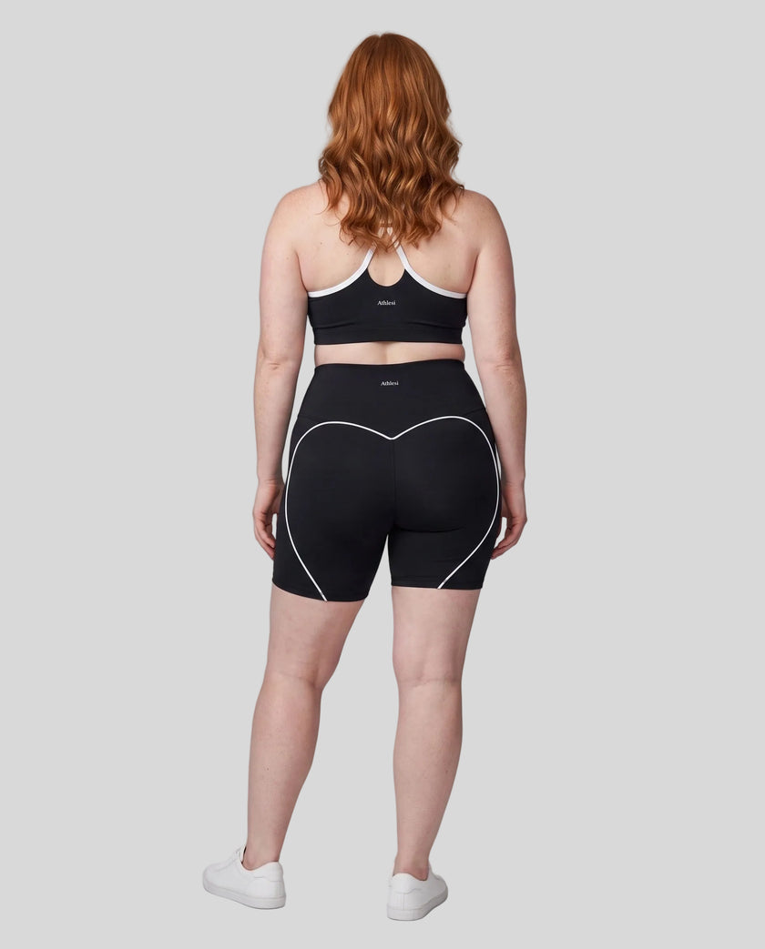 Full body back view of woman wearing black TrackLine Sculpt Sports Bra and matching TrackLine Sculpt Shorts