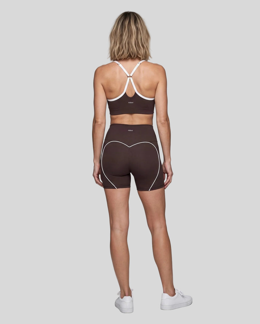 Full body back view of woman wearing brown TrackLine Sculpt Sports Bra and matching TrackLine Sculpt Shorts