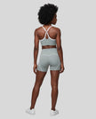 Full body back view of woman wearing haze blue TrackLine Sculpt Sports Bra and matching TrackLine Sculpt Shorts