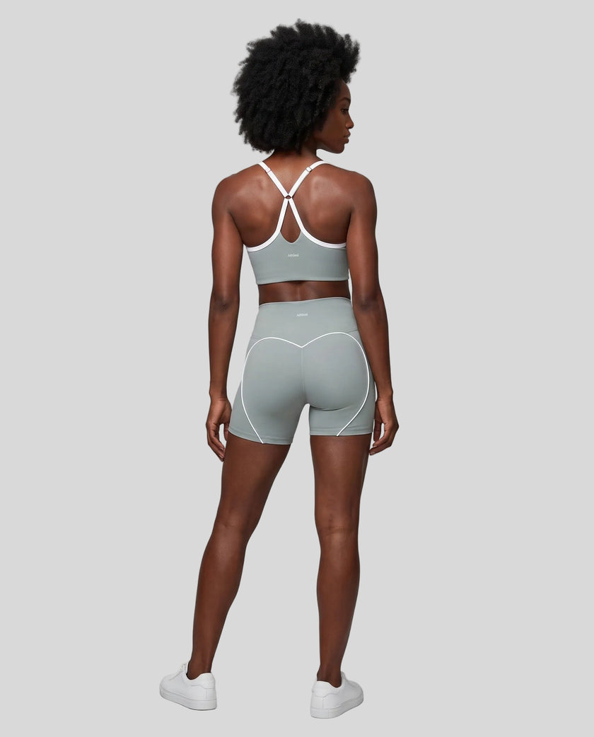 Full body back view of woman wearing haze blue TrackLine Sculpt Sports Bra and matching TrackLine Sculpt Shorts
