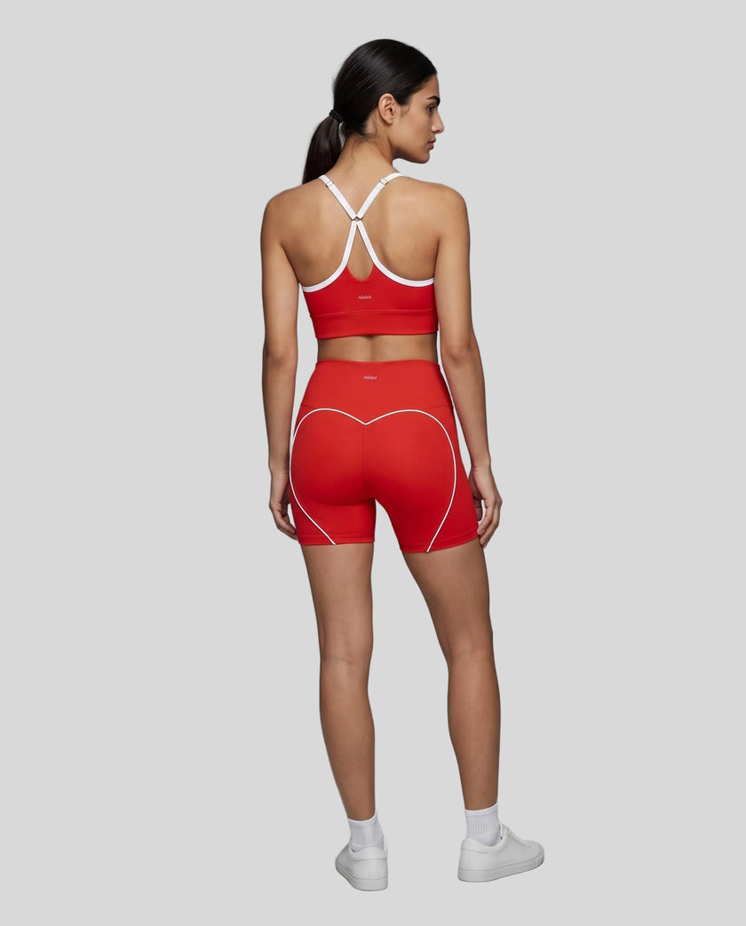 Full body back view of woman wearing red TrackLine Sculpt Sports Bra and matching TrackLine Sculpt Shorts