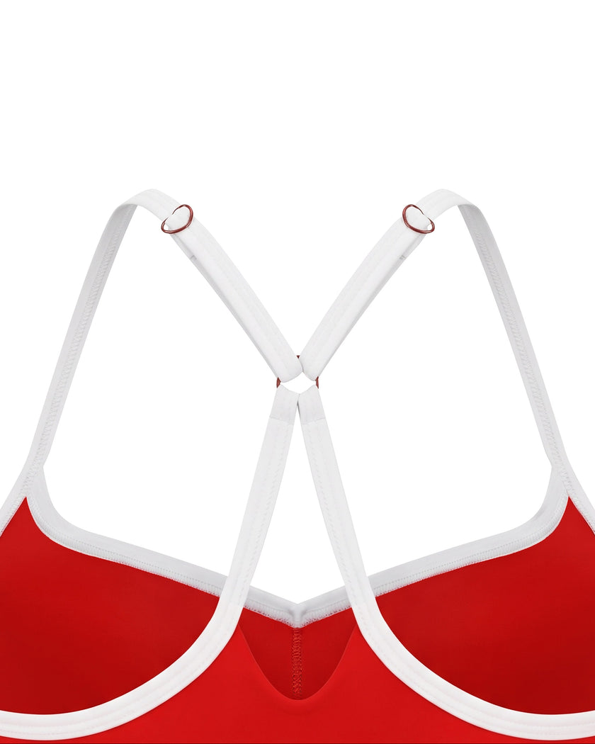 Closeup of white crossover back straps and metal ring details on TrackLine Sculpt Sports Bra