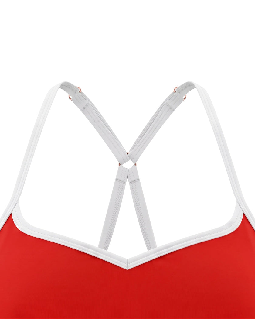 Closeup of V-shaped neckline with white contrast trim on red TrackLine Sculpt Sports Bra