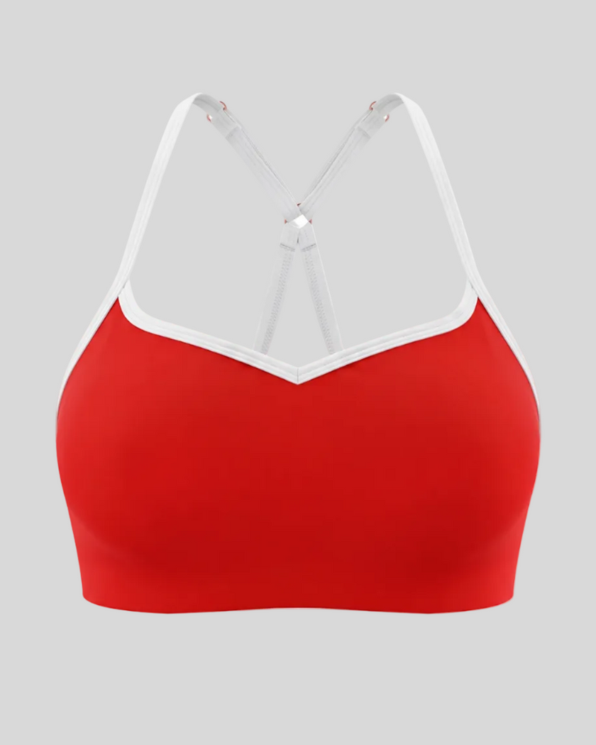 Front view of TrackLine Sculpt Sports Bra in red with white contrast trim and V-neckline