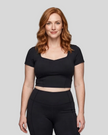 Upper body front view of woman wearing black TrackLine Sculpt Tee with sculpted neckline