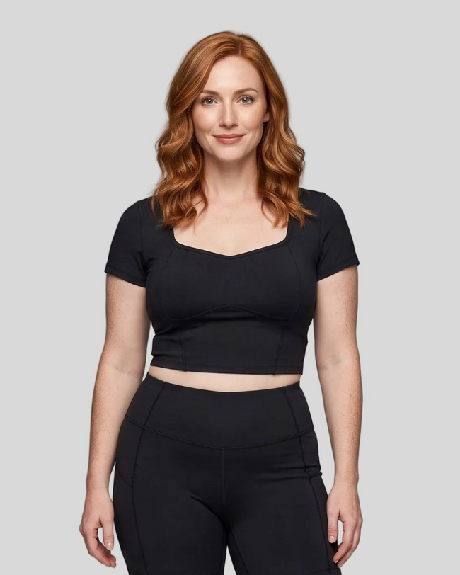 Upper body front view of woman wearing black TrackLine Sculpt Tee with sculpted neckline