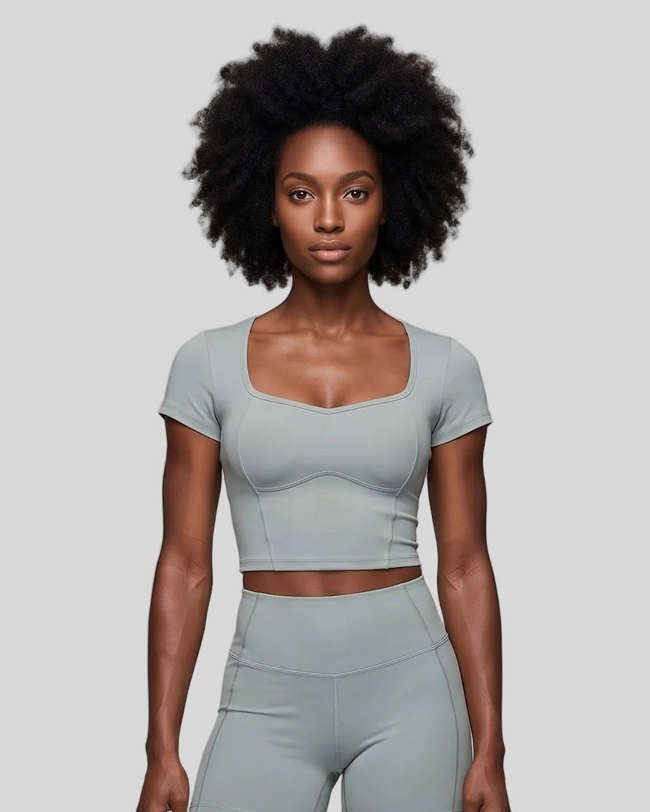 Upper body front view of woman wearing haze blue TrackLine Sculpt Tee with sculpted neckline