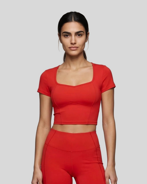 Upper body front view of woman wearing red TrackLine Sculpt Tee with sculpted neckline