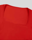 Closeup of geometric square-inspired neckline and contour stitching on red TrackLine Sculpt Tee