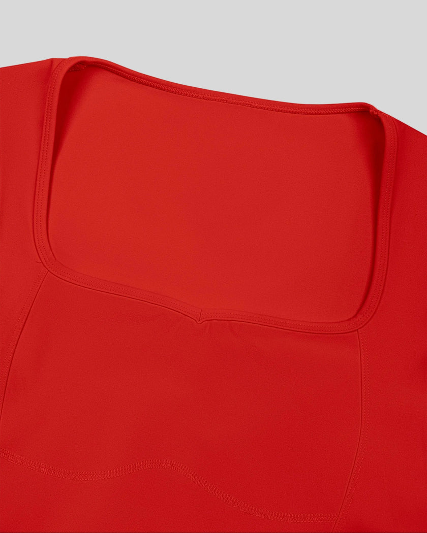 Closeup of geometric square-inspired neckline and contour stitching on red TrackLine Sculpt Tee