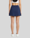 Lower body back view of a woman wearing the Athlesi TrackLine Slit Skirt in blue