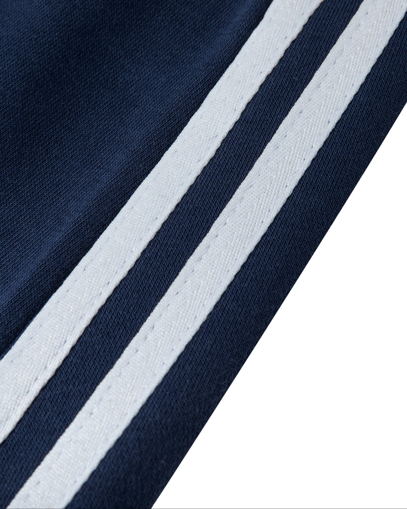 Closeup of the contrast side stripe detailing on the Athlesi TrackLine Slit Skirt in blue