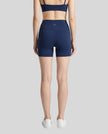 Back view of the TrackLine Sprint Shorts in navy blue on model