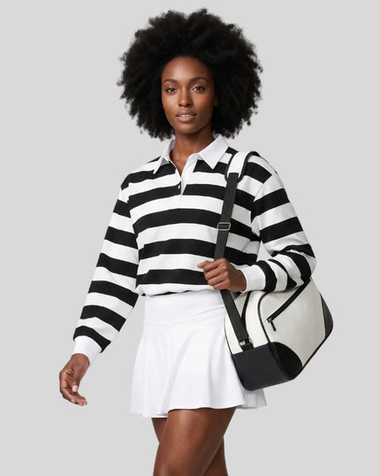 Model wearing the Athlesi TrackLine Striped Polo Shirt in black and white from a front angle