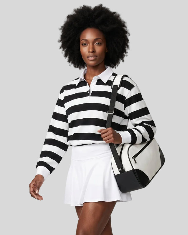 Model wearing the Athlesi TrackLine Striped Polo Shirt in black and white from a front angle