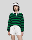 Model wearing the Athlesi TrackLine Striped Polo Shirt in green and navy blue, front view