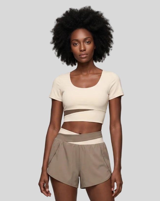 Woman wearing TrackLine Synergy Cropped Tee in Apricot with Khaki panel, front view