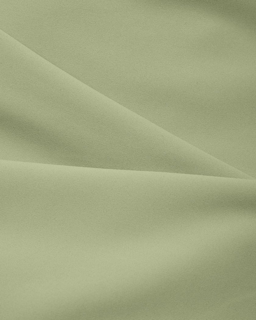 Close-up of smooth stretch fabric on TrackLine Synergy Cropped Tee in Bean Green