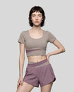 Woman wearing TrackLine Synergy Cropped Tee in Gray Purple with Misty Purple panel, front view