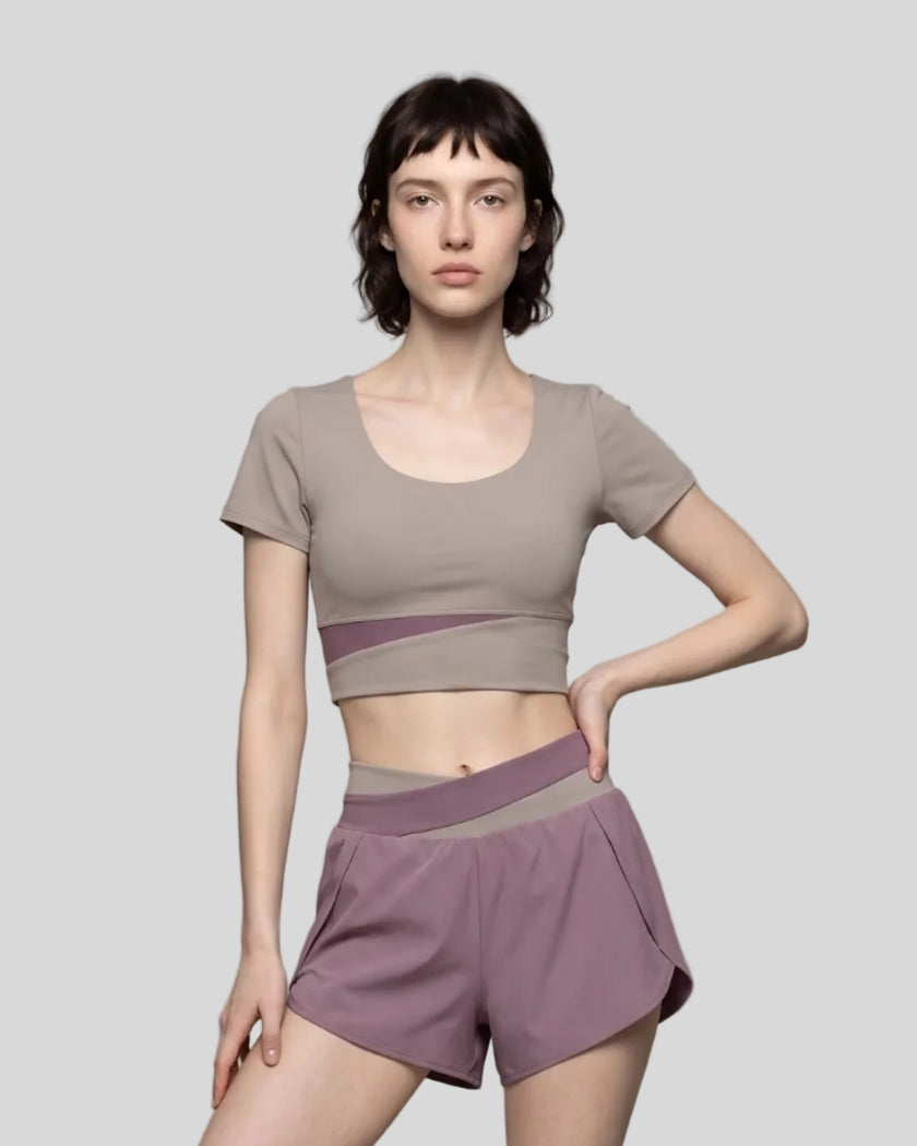 Woman wearing TrackLine Synergy Cropped Tee in Gray Purple with Misty Purple panel, front view
