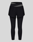 TrackLine Synergy Layered Leggings in black with dark gray crossover waistband and overlay shorts front view