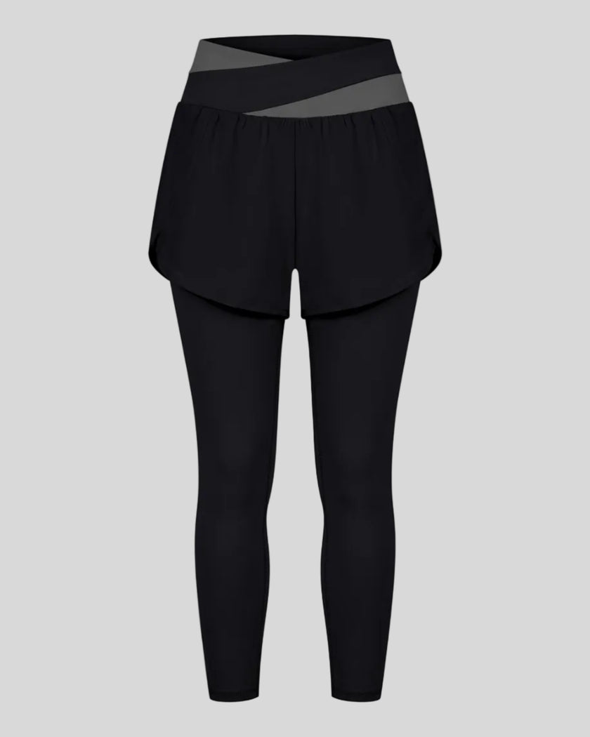 TrackLine Synergy Layered Leggings in black with dark gray crossover waistband and overlay shorts front view