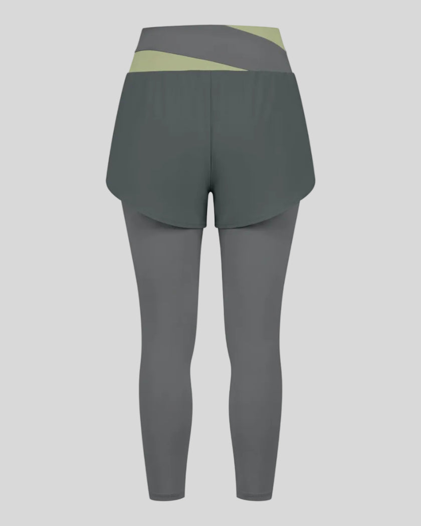 TrackLine Synergy Layered Leggings in dark gray with bean green crossover waistband and overlay shorts back view